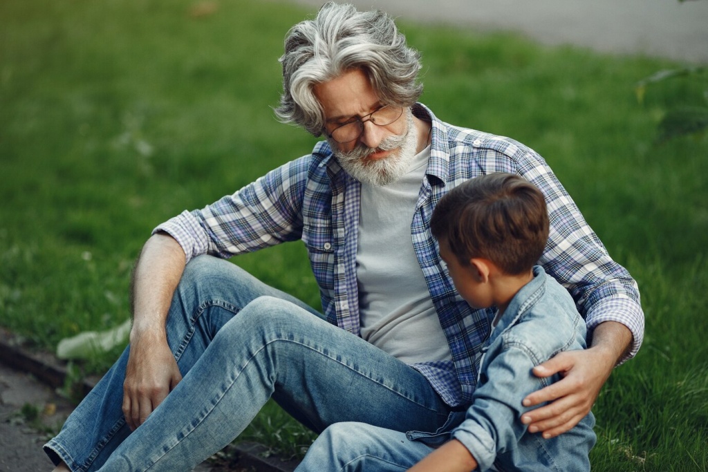 boy-and-grandfather-are-walking-in-the-park-old-man-playing-with-grandson-family-sitting-on-a-grass_1157-39127.jpeg